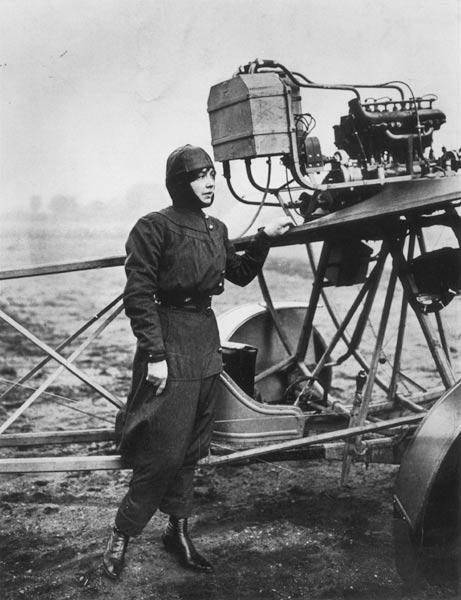 Helene Dutrieu (1877-1961) standing beside a plane, before 1914 (b/w photo) 