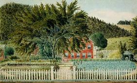 View of a Red House with a Picket Fence