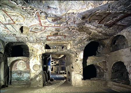Interior of a catacomb chamber cut from tufa stone showing fragments of frescoed decoration from Anonymous