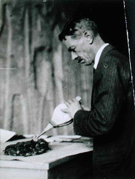 Mr Mace, Associate Curator of the Metropolitan Museum of Art, New York, treating one of the objects  from Harry Burton