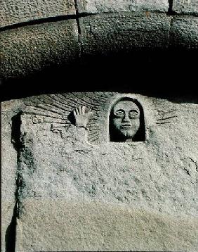 Relief depicting the head and face of a man, possibly God the Father, from the facade
