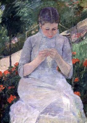 Young Woman Sewing in the garden