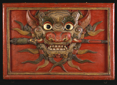 A Tibetan Polychrome Wooden Panel Carved In High Relief With A Kala Mask, 19th Century from 