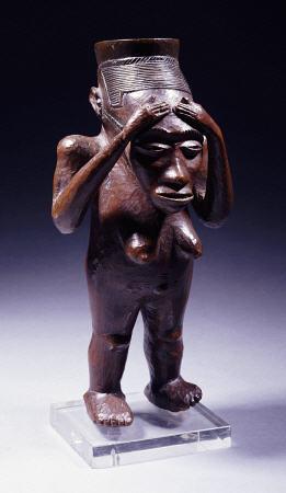 An Unusual Kuba Cup Carved As A Standing Female Figure With Hands Clasping The Forehead