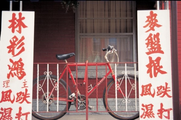 Bicycle at metal bars with Chinese board , Singapore (photo)  from 