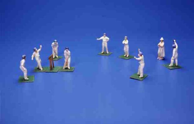 Eleven German bisque figures of cricketers and an umpire (painted lead) from 