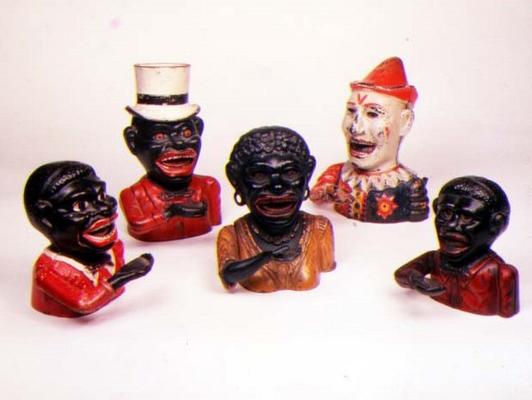 Group of Mechanical cast iron money banks. Left to right: Jolly Nigger with Butterfly Tie, Jolly Nig from 