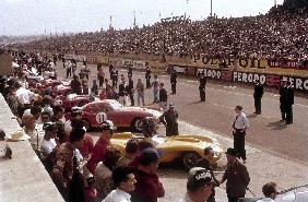 Le Mans racing circuit, France. The cars are lined up in the pits, with the spectator stands opposit