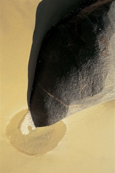 Unusual rock formation pointing a puddle on sand Vishakapatnam (photo)  from 