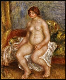 Nude woman on green cushions